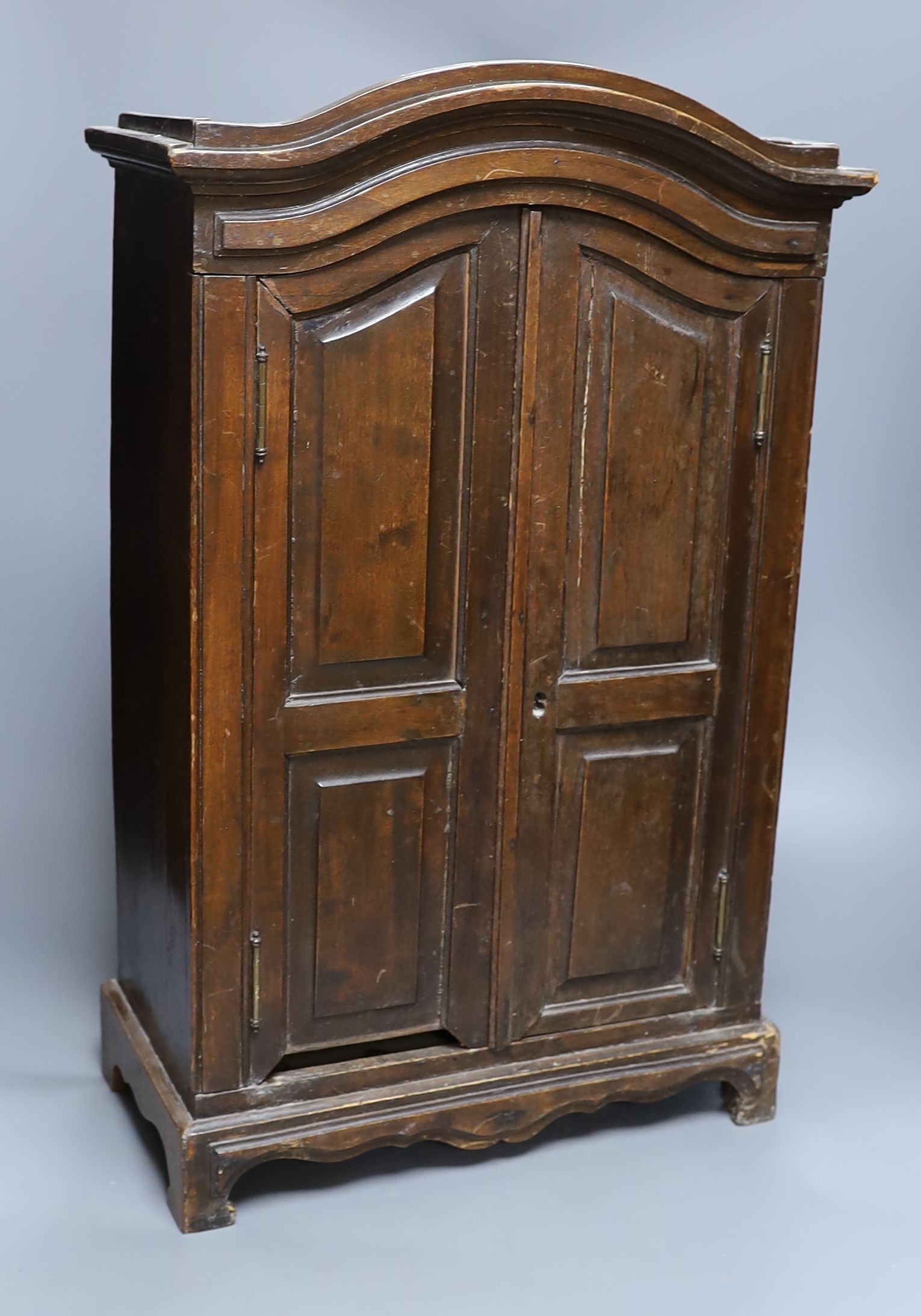 A miniature beech armoire, 57 cms high.